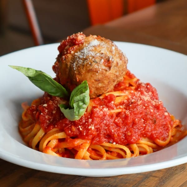 Bacco Centro's spaghetti with a large meatball, rich red sauce, parmesan, and fresh basil.