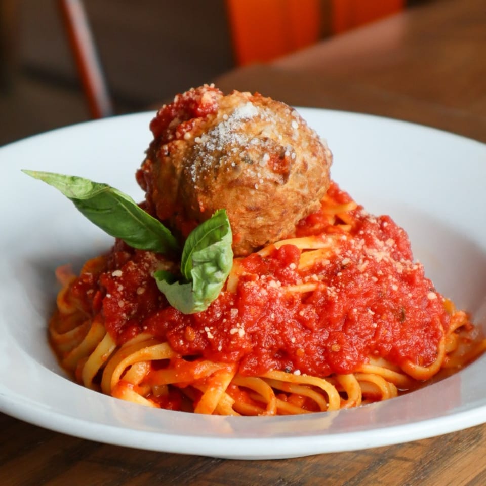 Bacco Centro's spaghetti with a large meatball, rich red sauce, parmesan, and fresh basil.