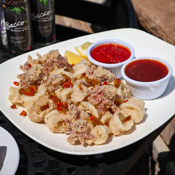 Bacco Centro's fried calamari with red chili flakes, lemon wedges, and two dipping sauces.